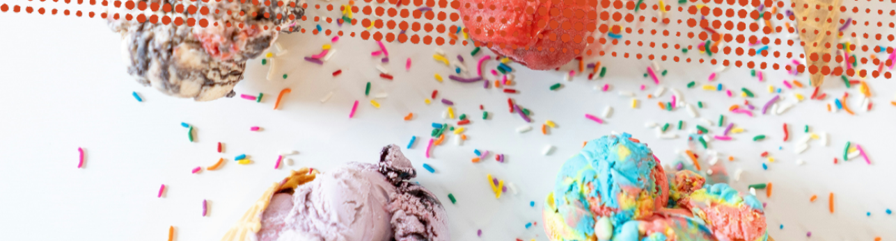 Scoops of colorful ice cream with sprinkles scattered on a white surface. The ice cream flavors appear vibrant, creating a playful and joyful mood.