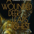 Book cover of "A Wounded Deer Leaps Highest" by Charlie J. Stephens. Features a close-up of a deer's eye, textured with dark, warm tones. The mood is intense and captivating.